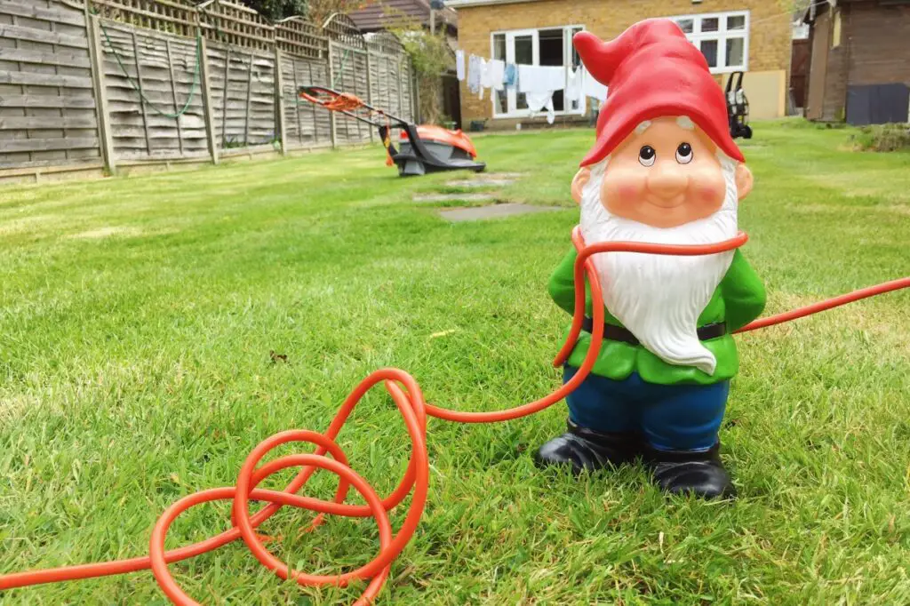 a gnome tripping over cables in garden